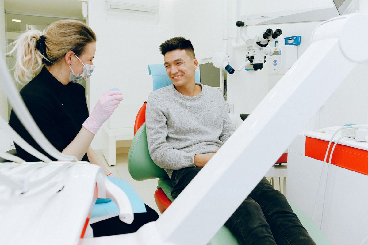 Patient and dental assistant chatting in the treatment room